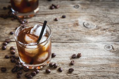 Siyah Rus kokteyl votka ve kahve likörü ile. Ev yapımı alkollü ayyaş siyah Rus iç ahşap zemin kopya alanı üzerine kahve çekirdekleri ile.