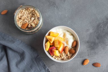 Ev yapımı yulaf ezmesi granola yoğurt ve şeftali kase sağlıklı kahvaltı için. Mısır gevreği granola ve meyve kahvaltı kase yoğurt ile.