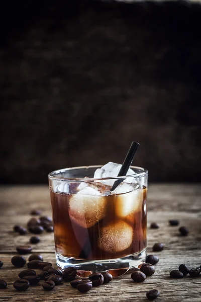 stock image Black Russian Cocktail with Vodka and Coffee Liquor. Homemade Alcoholic Boozy Black Russian drink with coffee beans on wooden background with copy space.