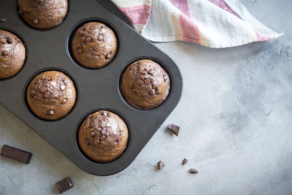 Chocolate Muffins with Chocolate Drops in bakeware. Homemade chocolate pastry for breakfast or dessert.