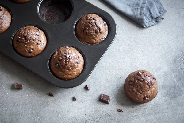 Double Chocolate Muffins with Chocolate Drops in bakeware. Homemade chocolate pastry for breakfast or dessert.