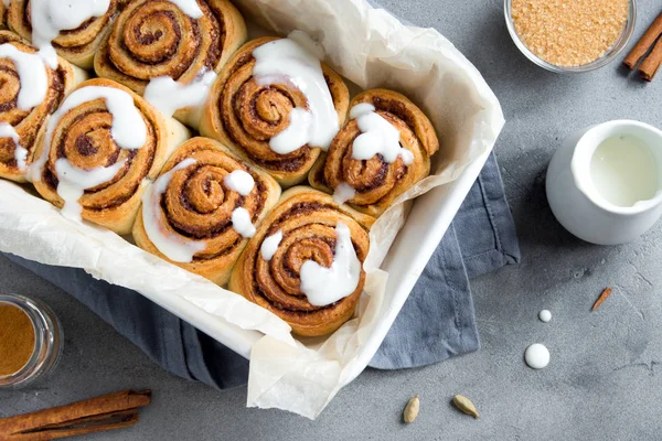 Rulo tarçın veya Cinnabon krema soslu ev yapımı tarifi hazırlık tatlı geleneksel tatlı çörekler pasta yemek. Gri beton masaya yiyecek ingridients için tarçın rulo.