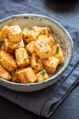 Kızarmış Tofu susam ve yeşillik ile bir kasede karıştırın. Ev yapımı sağlıklı vejetaryen Asya yemek - kızarmış tofu.