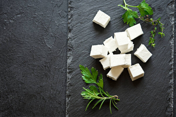 Fresh Greek Feta Cheese. Healthy ingredient for cooking salad. Goat feta cheese with herbs.