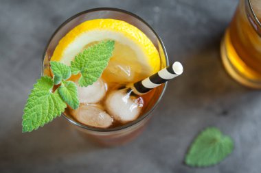 Buzlu çay limon, nane ve buz küpleri üzerinden kopya alanı gri beton arka plan ile. Buzlu soğuk yaz içeceği.