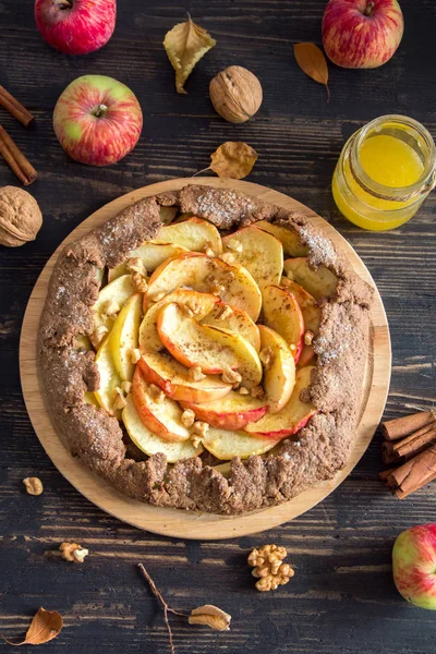 Apple Galette. Healthy homemade wholegrain fruit pie (galette) with organic apples, walnuts, honey and cinnamon, vegan vegetarian autumn dessert food for Thanksgiving.