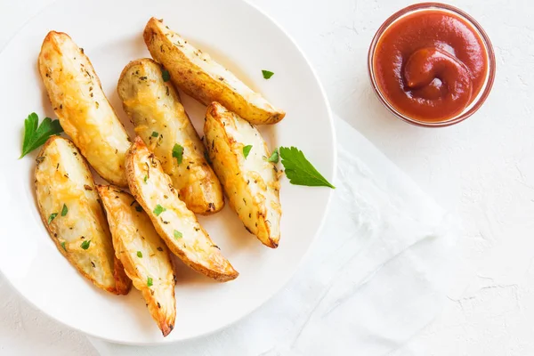 Patates dilimleri peynir ve ot ve beyaz tabakta - domates sosu ile pişmiş ev yapımı organik sebze vegan vejetaryen patates dilimleri aperatif yemek yemek.