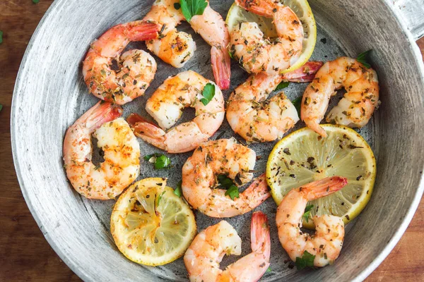 Limon, sarımsak ve otlar ile Kızarmış karides. Deniz ürünleri, shelfish. Baharat, sarımsak ve limon siyah taş zemin, kopya alanı üzerine karides karides ızgara. Karides karides Pan.
