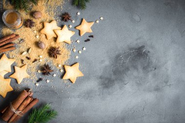 Baharatlar, gingerbread çerezleri ve pişirme malzemelerin üzerine gri beton, Noel yemeği arka plan boşluk kopyalayın. Noel kurabiyeleri için malzemeler.
