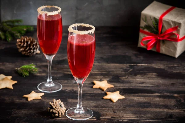 Mimosa festive drink for Christmas - champagne red cocktail Mimosa (mocktail) with cranberry for Christmas party, copy space