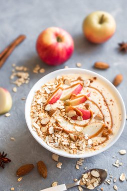 Elmalı turta güler yüzlü kase. Elma, tarçın, badem sütü, yulaf granola, tuzlu karamel ve baharatlar ile güler yüzlü kase Kahvaltı, görünümü top, yakın çekim.