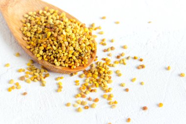 Arı polen içinde kaşık beyaz arka plan üzerinde. Sağlıklı organik ham diyet vejetaryen gıda içerikler - arı polen.