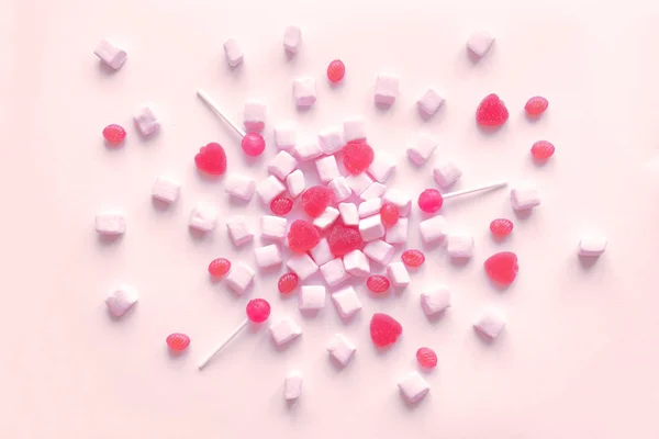 Pink candies and marshmallows pattern, background. Various pink sweets for Valentine Day as backdrop, top view.