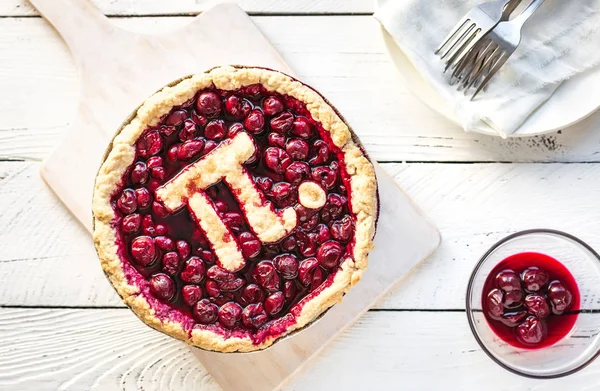 Pi Day Cherry Pie - Homemade Traditional Cherry Pie with Pi sign for March 14th holiday, on white wooden background, top view, copy space.