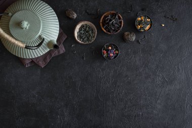 Çeşitli çay seçimi ve çaydanlık siyah arka plan, kopya alanı üzerine. Geleneksel Asya çay aranjman - demir demlik çay, üstten görünüm.