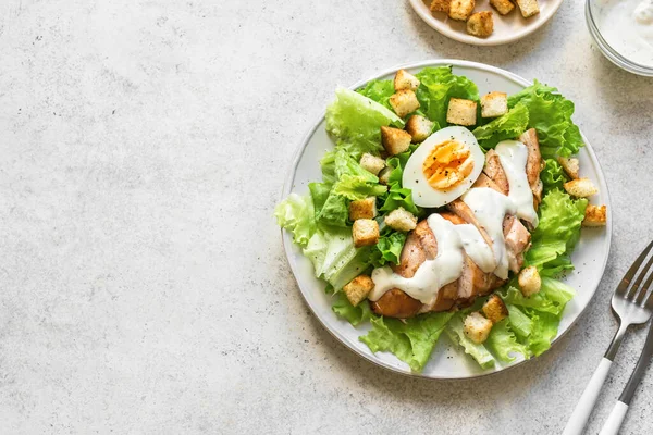Caesar salad with chicken breast on white background, top view, copy space. Fresh chicken salad for healthy lunch. — Stock Image Caesar Salad Chicken Breast White Background Top View Copy Space Stock Picture