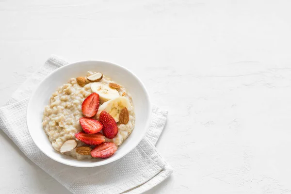 Oatmeal Porridge Strawberries Almonds Banana White Table Healthy Breakfast Oatmeal — Stock Photo, Image