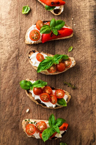Bruschetta Sandwiches Tomatoes Cream Cheese Grilled Paprika Basil Wooden Background — Stock Photo, Image