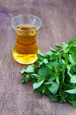 Saydam bir cam taze sağlıklı nane çayı. Yeşil nane yaprağı. Organik.