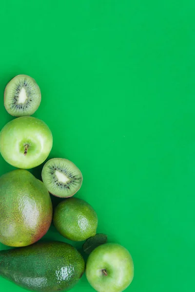 Creative background of green various summer tropical fruits. Food concept for fitness dinner,plant based diet,frutarian,healthy eating — Stock Photo, Image