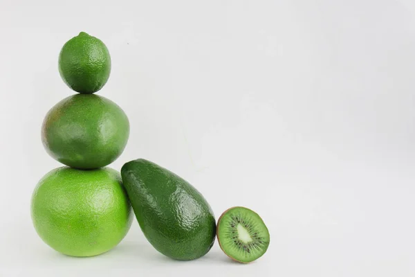 Creative background of green various summer tropical fruits. Food concept for fitness dinner,plant based diet,frutarian,healthy eating — Stock Photo, Image