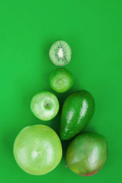 Creative background of green various summer tropical fruits. Food concept for fitness dinner,plant based diet,frutarian,healthy eating — Stock Photo, Image