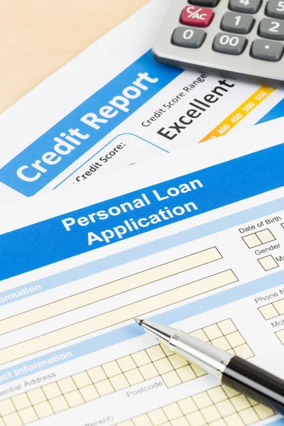 Personal loan application form excellent credit score with calculator, and pen