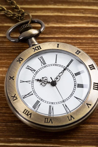 Vintage pocket watch clock on wooden background — Stock Photo, Image