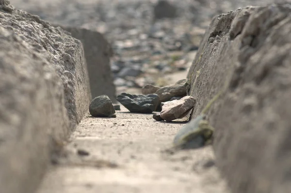 River stones in a tunnel made of concrete slab.