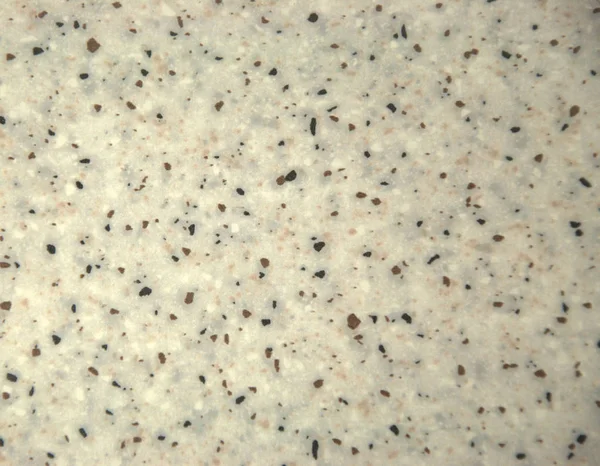 White granite with black impregnations. A close-up shot.