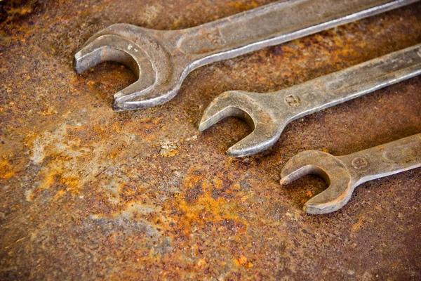 Auto repair shop concept, repair of cars, motorcycles. Old pliers, hammer and cutter on a rusty iron sheet. Wrenches in garage, set of wrenches handy industrial tool,old wrenches in mechanic workshop,handy tool for motor vehicle.