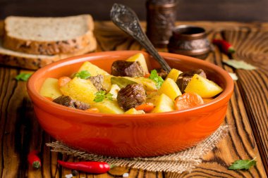 Beef stew with vegetables potatoes, carrots, delicious autumn dish, gravy sauce clipart
