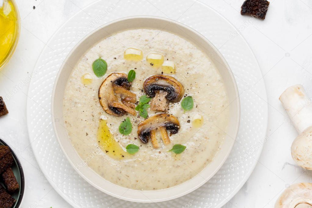 Mushroom cream soup with cream, croutons of dark bread, olive oil, delicious healthy food