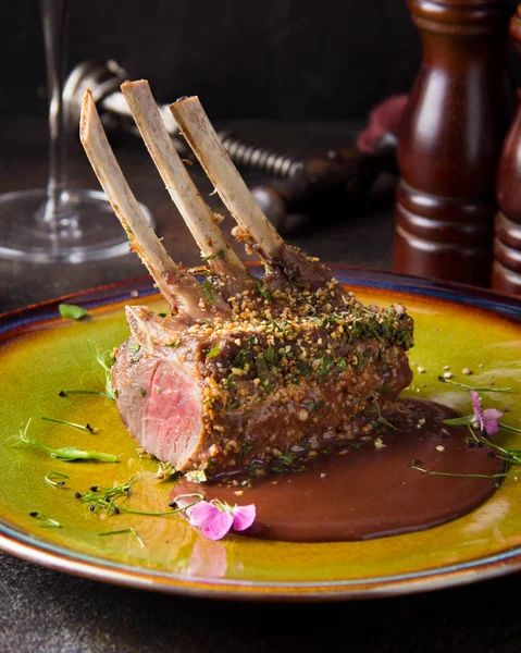 Rack Lamb Breaded Pistachio Nuts Dark Sauce Herbs Pink Meat — Stock Photo, Image