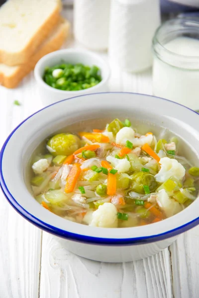Karnabahar, Brüksel lahanası, beyaz lahana, havuç ve yeşil bezelye ile sebze çorbası. Vejetaryen ve çocuk için bahar gıda lezzetli sağlıklı öğle yemeği