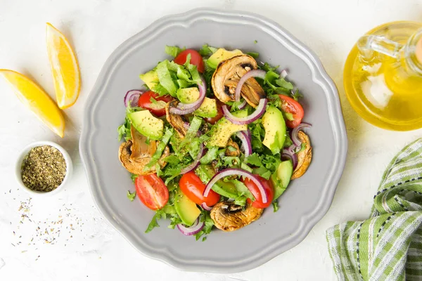 Taze bahar mantar, domates, soğan ve avokado salatası. Lezzetli vejetaryen yemek, sağlıklı gıda