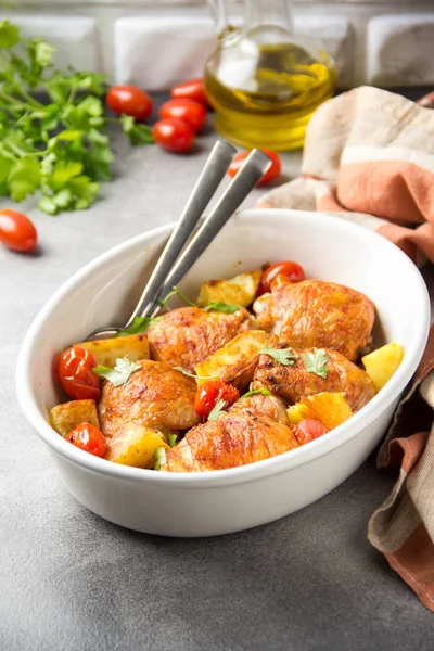 Baked chicken thighs (legs) with crispy crust, potatoes and cher — Stock Photo, Image