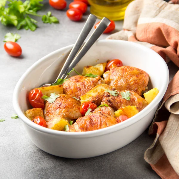 Baked chicken thighs (legs) with crispy crust, potatoes and cher — Stock Photo, Image