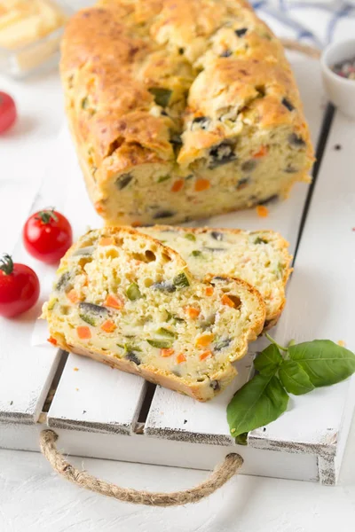 Snack cake with vegetables (zucchini, eggplant, carrot, tomato) and cheese. A tasty lunch, food, healthy baking