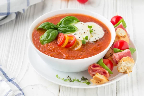 Tomato cold gazpacho soup with vegetables, mozzarella, salami, c — Stock Photo, Image