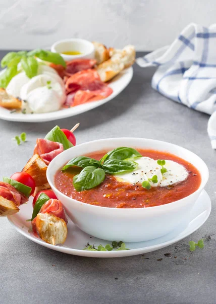 Tomato cold gazpacho soup with vegetables, mozzarella, salami, c — Stock Photo, Image