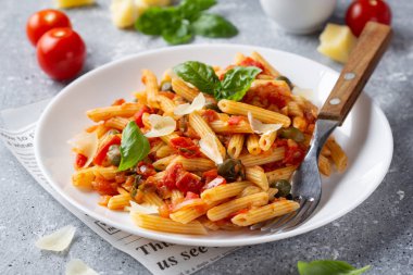 Traditional pasta putanesca with tomato sauce (capers, onions, g clipart