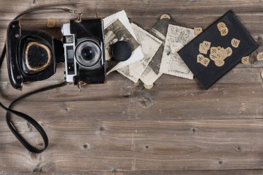 Kopya alanı rustik ahşap kurulları zemin üzerine eski retro film kamerası ve fotoğraf üstten görünüm.