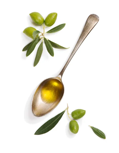 Olívaolaj gyümölcsök és kanállal olívaolajjal. Stock Kép