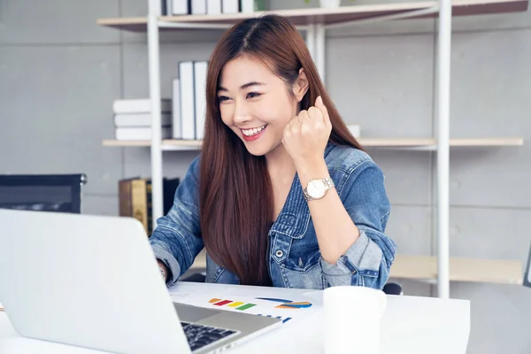 asia woman with laptop celebrating success concept, education or technology or startup business concept