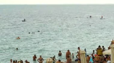 Yaz aylarında plaj bir sürü insan yüzmek ve denizde eğlenmek, tekneler ve tekneler Yalta 4k zaman atlamalı yelken