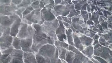 Şeffaf su güzel desenler 4k yavaş hareket oluşturarak güneş tarafından aydınlatılır