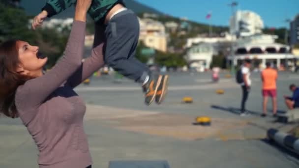 Une jeune mère et son fils marchent dans la ville — Video