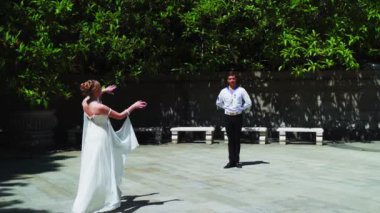 Genç bir adam ve bir kız vals yapıyorlar. Bir öğrenci ve beyaz balo elbisesi giymiş bir kız parkta dans ediyorlar. Yavaş çekimde vals dansı.