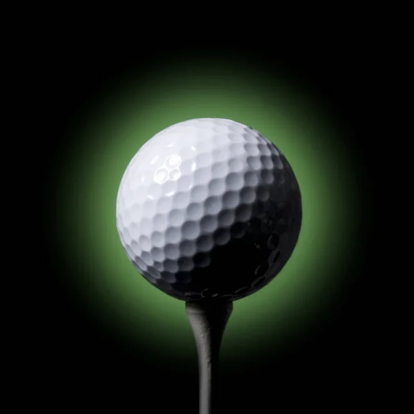 Golf Ball Tee Black Background Green Rim Light — Stock Photo, Image